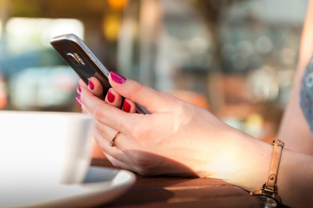 Hands holding a mobile phone