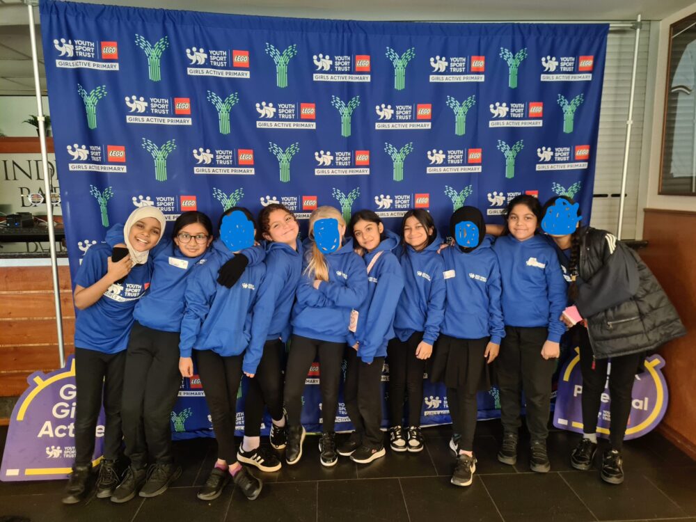 Girls in front of the Sports Leaders banner